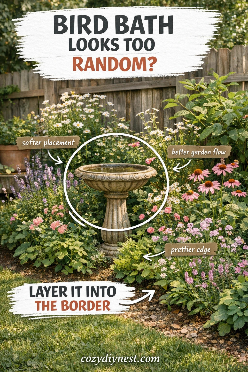 Bird bath layered into a flower border in a small backyard garden
